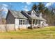 Charming gray home featuring a cozy front porch and a well-manicured lawn at 400 Joe Cloninger Rd, Bessemer City, NC 28016