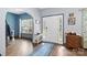 Bright foyer featuring hardwood floors, a white door, and a window view to the front porch at 400 Joe Cloninger Rd, Bessemer City, NC 28016