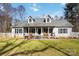 Charming home featuring a cozy front porch with rocking chairs and a well-manicured lawn at 400 Joe Cloninger Rd, Bessemer City, NC 28016