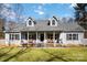 Charming home featuring a cozy front porch with rocking chairs and a well-manicured lawn at 400 Joe Cloninger Rd, Bessemer City, NC 28016