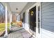 The front porch features a wooden chair, sidelight windows, and a sunflower wreath at 400 Joe Cloninger Rd, Bessemer City, NC 28016