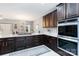 Modern kitchen showcasing quartz counters, dark cabinets, stainless appliances and gas cooktop at 400 Joe Cloninger Rd, Bessemer City, NC 28016