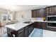 Kitchen with white quartz countertops, dark cabinets, stainless steel appliances and open to the dining room at 400 Joe Cloninger Rd, Bessemer City, NC 28016