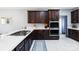 Modern kitchen with quartz counters, dark cabinetry, stainless appliances, and gas cooktop at 400 Joe Cloninger Rd, Bessemer City, NC 28016