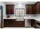 Modern kitchen with stainless steel appliances, a farmhouse sink, and dark wood cabinetry at 400 Joe Cloninger Rd, Bessemer City, NC 28016