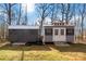 Two outbuildings with gray siding and a silver metal roof, near trees in the backyard at 400 Joe Cloninger Rd, Bessemer City, NC 28016