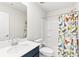 A well-lit bathroom has a blue vanity, mirror, toilet, and shower with bird themed curtain at 4069 Havenport Cir, Fort Mill, SC 29708