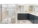Modern bathroom with glass shower, double sinks, and a decorative rug at 4069 Havenport Cir, Fort Mill, SC 29708