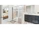 Elegant bathroom featuring a glass shower, dark cabinets, and bright countertops at 4069 Havenport Cir, Fort Mill, SC 29708