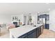 Modern kitchen with a large island flowing into a cozy living area with a fireplace at 4069 Havenport Cir, Fort Mill, SC 29708