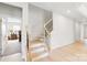 A naturally lit staircase with wood and iron banisters lead to the upper level of the home at 4069 Havenport Cir, Fort Mill, SC 29708