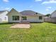 Back exterior featuring a patio and well-maintained lawn for outdoor enjoyment at 4101 New Castle Ln, Monroe, NC 28110