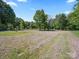 Spacious backyard with mature trees and fencing for a private outdoor retreat at 4101 New Castle Ln, Monroe, NC 28110