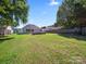 Fenced backyard with ample space, mature trees, offering privacy and relaxation at 4101 New Castle Ln, Monroe, NC 28110