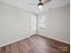 Minimalist bedroom features hardwood floors, neutral walls, ceiling fan, and natural light at 4101 New Castle Ln, Monroe, NC 28110
