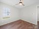 Bright bedroom with ceiling fan, hardwood floors, neutral walls, and a window at 4101 New Castle Ln, Monroe, NC 28110