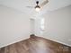 Simple bedroom featuring neutral walls, ceiling fan, and hardwood flooring at 4101 New Castle Ln, Monroe, NC 28110