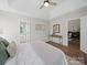 This bedroom boasts hard wood flooring, fresh paint, an ensuite, and neutral decor at 4101 New Castle Ln, Monroe, NC 28110