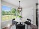 Sun-filled breakfast nook offers backyard views and modern chandelier lighting at 4101 New Castle Ln, Monroe, NC 28110