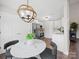 Bright breakfast nook boasts a lovely view and an elegant modern chandelier at 4101 New Castle Ln, Monroe, NC 28110