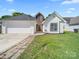 Charming one-story home featuring an attached two-car garage and a well-maintained front lawn at 4101 New Castle Ln, Monroe, NC 28110