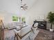 Vaulted ceilings and a modern fan accent this living room with bright natural light at 4101 New Castle Ln, Monroe, NC 28110