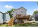 Spacious backyard with a two-story deck, green lawn, and mature trees at 414 King St, Waxhaw, NC 28173