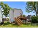 Spacious backyard with a two-story deck, green lawn, and mature trees at 414 King St, Waxhaw, NC 28173