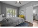 Cozy bedroom with a ceiling fan, large windows, and a view of the outdoors at 414 King St, Waxhaw, NC 28173