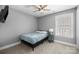 Simple bedroom with a ceiling fan, carpet, window, and wall-mounted TV at 414 King St, Waxhaw, NC 28173