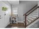 Welcoming entryway with white door, wooden staircase, and decorative shelving at 414 King St, Waxhaw, NC 28173