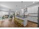 Bright, open kitchen with an island, hardwood floors and connected to the living area at 414 King St, Waxhaw, NC 28173