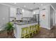 Open-concept kitchen with a large island, stainless appliances, hardwood floors and bright lighting at 414 King St, Waxhaw, NC 28173