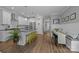 Open kitchen, island with barstool seating, stainless appliances, and hardwood floors at 414 King St, Waxhaw, NC 28173