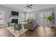 Cozy living room with fireplace, large windows, ceiling fan, and access to outdoor patio at 414 King St, Waxhaw, NC 28173