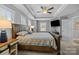 Main bedroom featuring a wooden bedframe, tray ceiling, and recessed lighting at 414 King St, Waxhaw, NC 28173