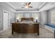 Spacious main bedroom with a large bed, ceiling fan, and tray ceiling at 414 King St, Waxhaw, NC 28173