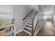 Interior staircase with hardwood treads, white risers, and stained handrail at 414 King St, Waxhaw, NC 28173