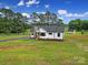 Aerial view of a home surrounded by green lawn, driveway and a storage shed at 456 Rainbow Cir, Clover, SC 29710