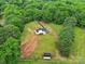 Aerial view of home with outdoor building on expansive lot with lawn and wooded perimeter at 456 Rainbow Cir, Clover, SC 29710