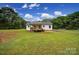Expansive backyard with lush lawn and home featuring a wooden porch and patio at 456 Rainbow Cir, Clover, SC 29710