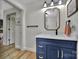 Bathroom vanity with blue cabinets, quartz countertop, mirror, and luxury gold hardware at 456 Rainbow Cir, Clover, SC 29710