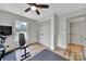 This home exercise room features a ceiling fan, neutral paint, and wood flooring at 456 Rainbow Cir, Clover, SC 29710