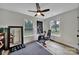 This is a home exercise room with wood floors, lots of natural light, and a ceiling fan at 456 Rainbow Cir, Clover, SC 29710