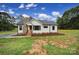 Charming home with stone chimney accent, a well-manicured lawn, and tasteful landscaping at 456 Rainbow Cir, Clover, SC 29710