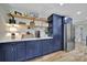Modern kitchen with custom navy cabinets, open shelving, and stainless steel refrigerator at 456 Rainbow Cir, Clover, SC 29710