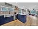 Bright kitchen with a stainless steel farmhouse sink and decorative backsplash with navy blue cabinets at 456 Rainbow Cir, Clover, SC 29710