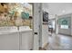 This laundry room includes a washer and dryer, floral wallpaper, and wire shelving at 456 Rainbow Cir, Clover, SC 29710