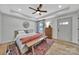 A primary bedroom features wood flooring, an area rug, a ceiling fan, and lots of natural light at 456 Rainbow Cir, Clover, SC 29710
