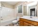 Bathroom features a vanity with a white countertop, a window, and a shower-tub combo at 4751 Kemp Dellinger Rd, Maiden, NC 28650